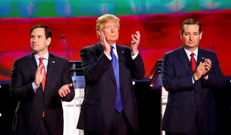 Republican U.S. Presidential candidates (L-R) Senator Marco Rubio, businessman Donald Trump and Senator Ted Cruz applaud before the start of the debate sponsored by CNN for the 2016 Republican U.S. presidential candidates in Houston, Texas, February 25, 2016. REUTERS/Mike Stone