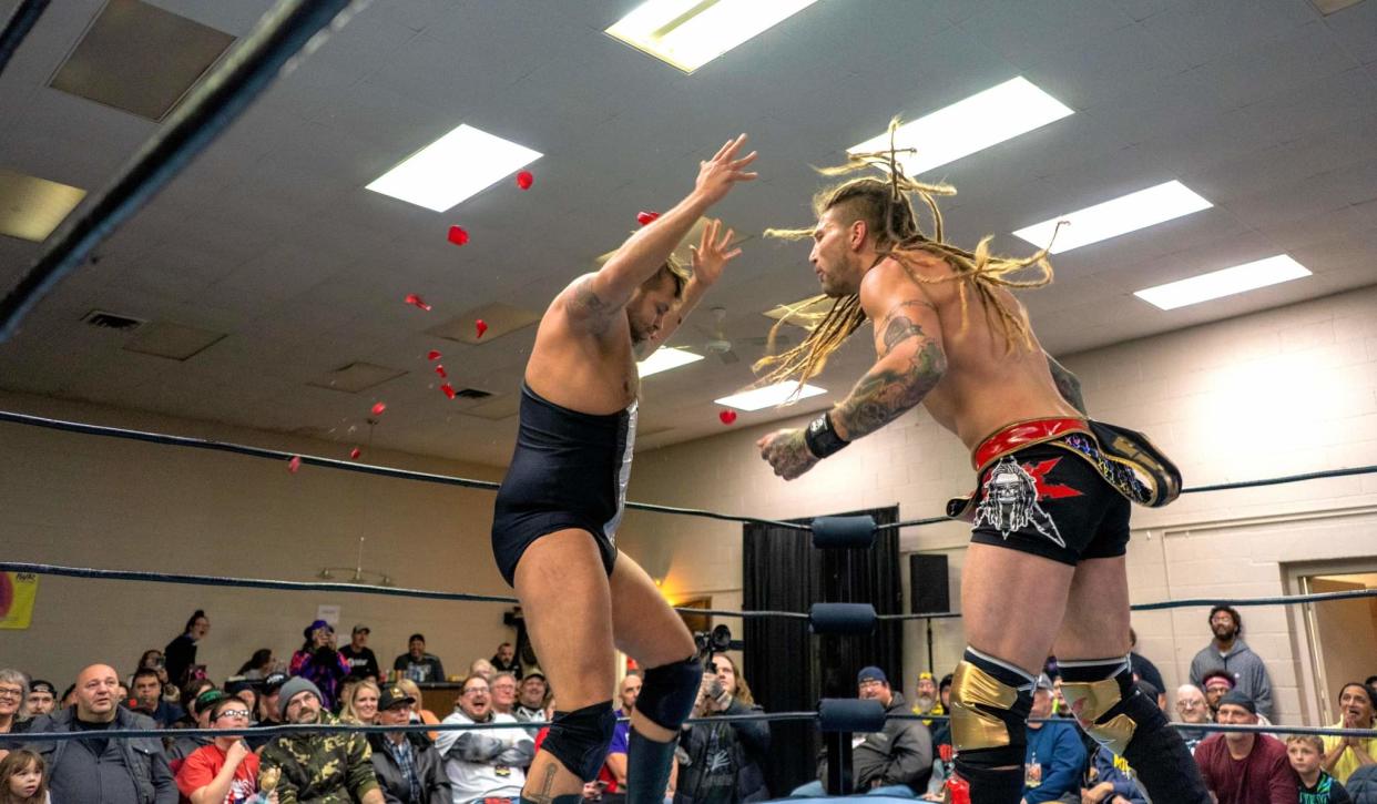 The Main Event Monster Madman Fulton, right, spits the petals of a rose given to him by The Bachelor Ben Boone back at Boone before an enthusiastic crowd at Insane Wrestling Revolution's IWR 16 — Goresgiving Nov. 30 at the FOP Hall in Monroe.