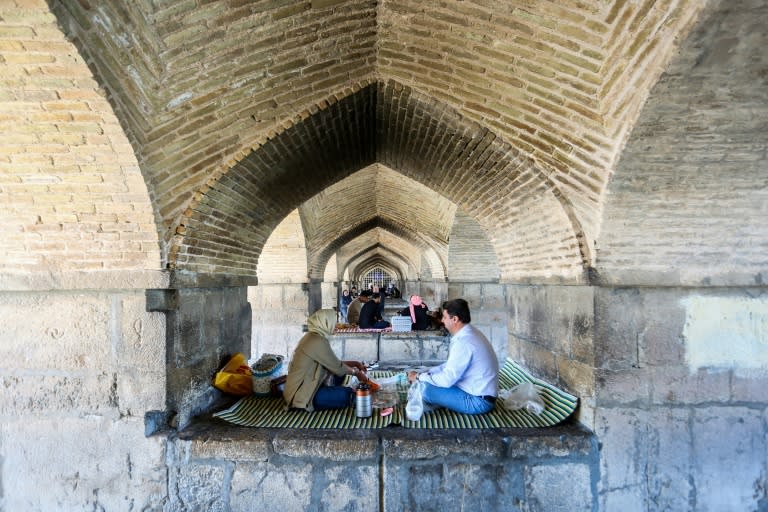 People picnic under the Si-o-Se Pol Bridge in Isfahan after the reported explosions (Rasoul SHOJAEI)