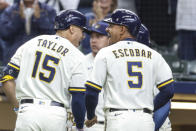 Milwaukee Brewers' Tyrone Taylor and teammate Eduardo Escobar react after Taylor's grand slam against the St. Louis Cardinals during the first inning of a baseball game Thursday, Sept. 23, 2021, in Milwaukee. (AP Photo/Jeffrey Phelps)