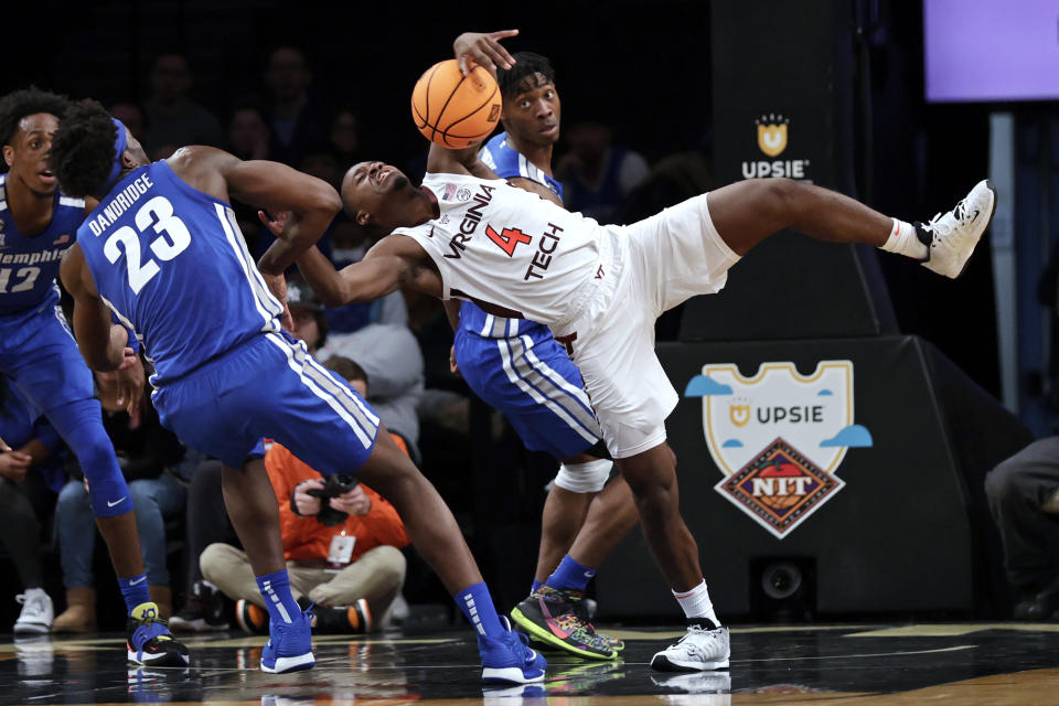 Virginia Tech's Nahiem Alleyne (4) battles for the ball with Memphis' Malcolm Dandridge (23) during the first half of an NCAA college basketball game in the NIT Season Tip-Off tournament Wednesday, Nov. 24, 2021, in New York. (AP Photo/Adam Hunger)