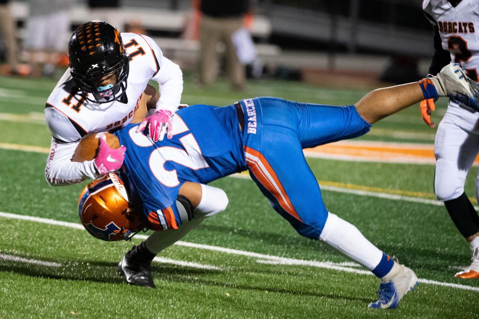 Kaden Hamilton (11) is brought down hard by Aaron Johnson (22) during the YAIAA football game between York High and Northeastern at Smalls Athletic Field, Friday, October 18, 2019. The Bearcats defeated the Bobcats 32-7.