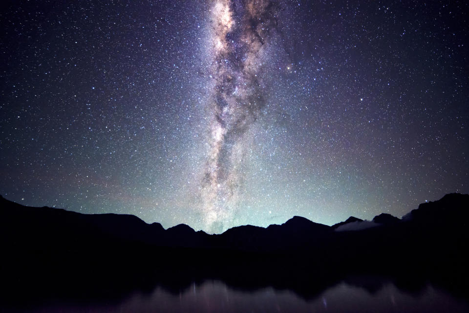 a bright white band of stars streaks across the night sky