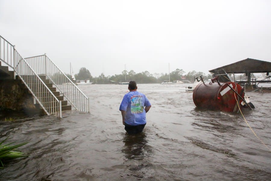 Daniel Dickert wades through water after the Steinhatchee River flooded on Wednesday, Aug. 30, 2023, in Steinhatchee, Fla., after the arrival of Hurricane Idalia. (Douglas R. Clifford/Tampa Bay Times via AP)