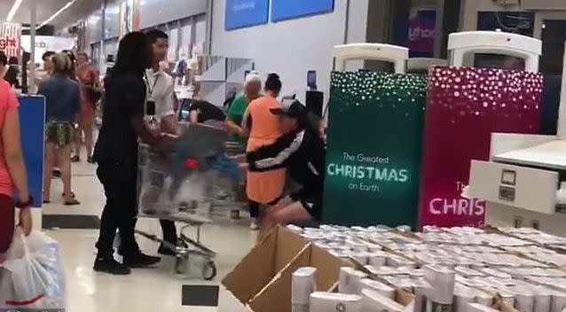 The woman becomes aggressive when the employee takes hold of her trolley but she refuses to let it go. Source: Facebook