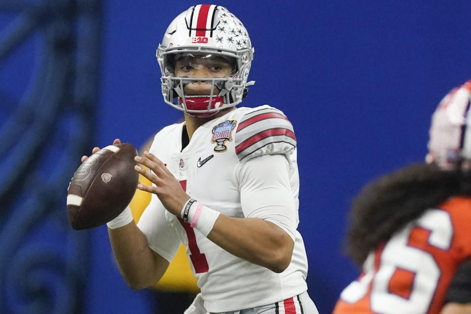 FILE - In this Friday, Jan. 1, 2021, file photo, Ohio State quarterback Justin Fields passes against Clemson during the second half of the Sugar Bowl NCAA college football game in New Orleans. Fields is foregoing his senior season to enter the NFL draft, in an announcement posted on social media, Monday, Jan. 18, 2021. Fields, expected to be a first-round draft choice, went 20-2 as a two-year starter for the Buckeyes. (AP Photo/John Bazemore, File)