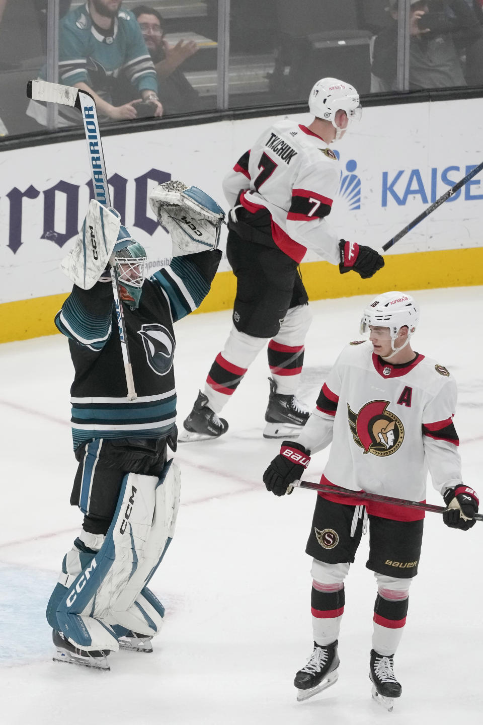 San Jose Sharks goaltender Magnus Chrona, left, celebrates next to Ottawa Senators left wing Brady Tkachuk (7) and center Tim Stützle after the Sharks defeated the Senators in an NHL hockey game in San Jose, Calif., Saturday, March 9, 2024. (AP Photo/Jeff Chiu)