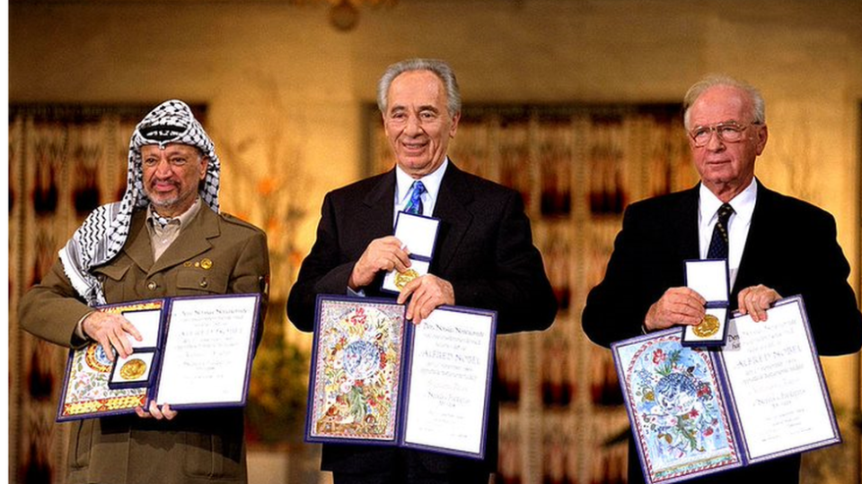 Yasser Arafat posa con el premio de 1994 junto al ex primer ministro israelí Isaac Rabin (i) y el ministro israelí de Exteriores Shimon Peres.