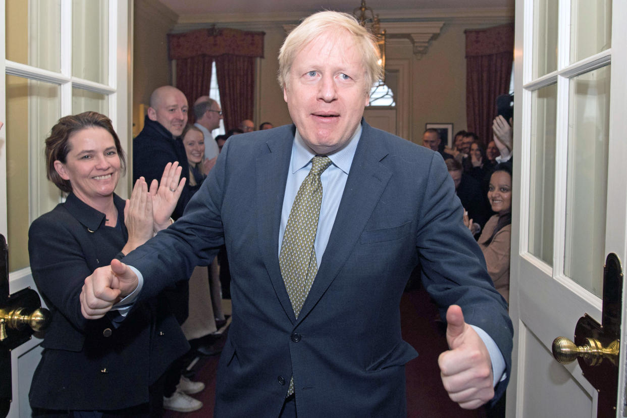 Prime Minister Boris Johnson is greeted by staff as he arrives back at 10 Downing Street, London, after meeting Queen Elizabeth II and accepting her invitation to form a new government after the Conservative Party was returned to power in the General Election with an increased majority.