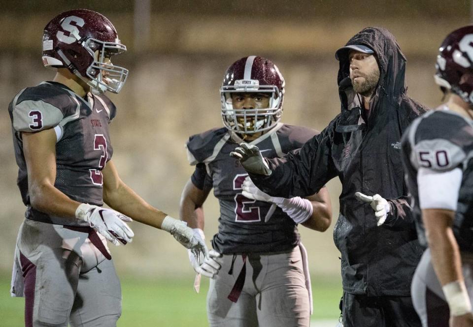 State College football coach Matt Lintal, seen in a file photo with Keaton Ellis and Cohen Russell, said Ellis has continued to stay involved with the program.