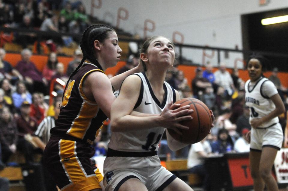 Adena's Kamryn Sowers (#11) muscles past a Federal Hocking defender during the Warriors' 48-36 loss to the Lancers in the Division III district semifinals at Waverly Downtown Gym on Feb. 24, 2024, in Waverly, Ohio.