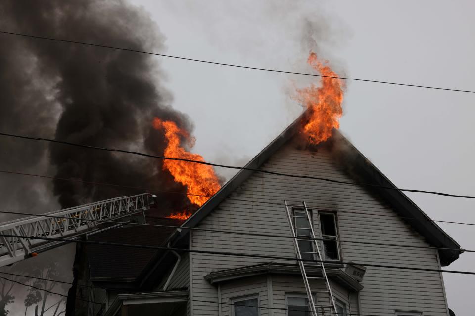 Brockton firefighters battle a three-alarm fire at 148 Florence Street at a multi-family home on Saturday, May 21, 2022.  