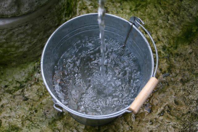 <p>Getty</p> Stock image of water pouring into a bucket.