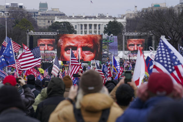 FILE - In this Jan. 6, 2021, file photo, the face of President Donald Trump appears on large screens as supporters participate in a rally in Washington. The House committee investigating the violent Jan. 6 Capitol insurrection, with its latest round of subpoenas in September 2021, may uncover the degree to which former President Donald Trump, his campaign and White House were involved in planning the rally that preceded the riot, which had been billed as a grassroots demonstration. (AP Photo/John Minchillo, File)