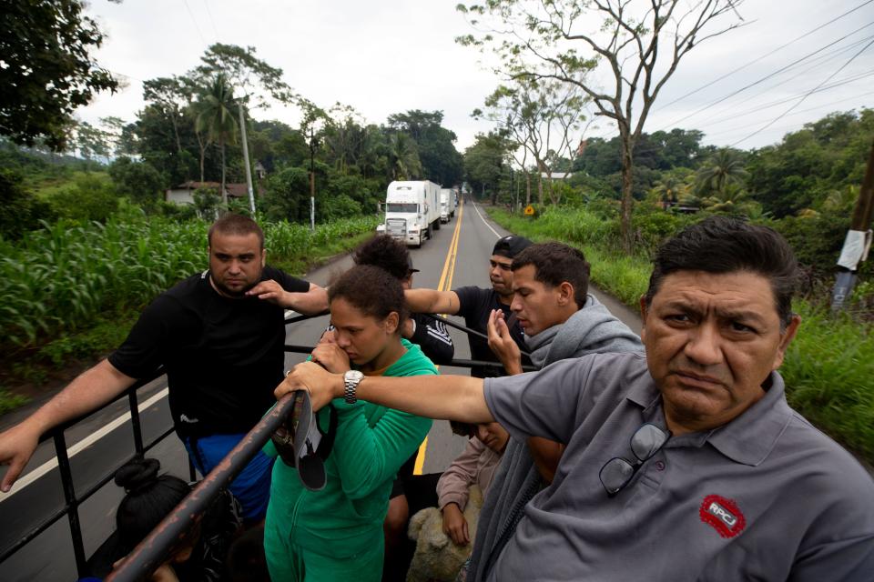 Migrants from Venezuela head north from Mazetenango, Guatemala on a private truck on Highway 2 that offered them a ride after a blockade prevented public transportation from heading north on Oct. 8, 2023.