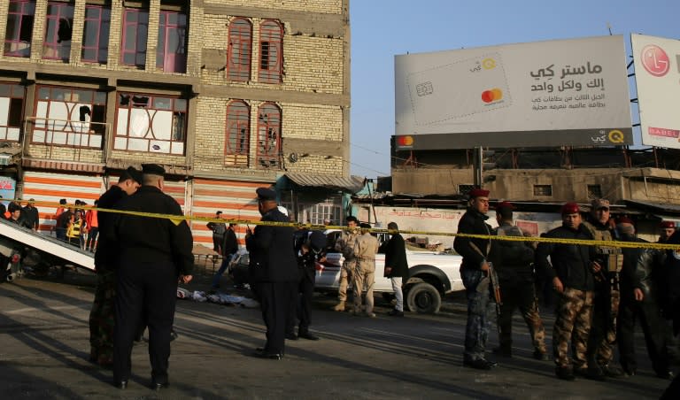 Iraqi security forces cordon off the area where a double suicide bombing killed 26 people in central Baghdad