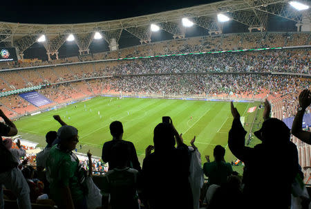 Saudi women cheer during a soccer match between Al-Ahli and Al-Batin at the King Abdullah Sports City in Jeddah, Saudi Arabia January 12, 2018. REUTERS/Reem Baeshen