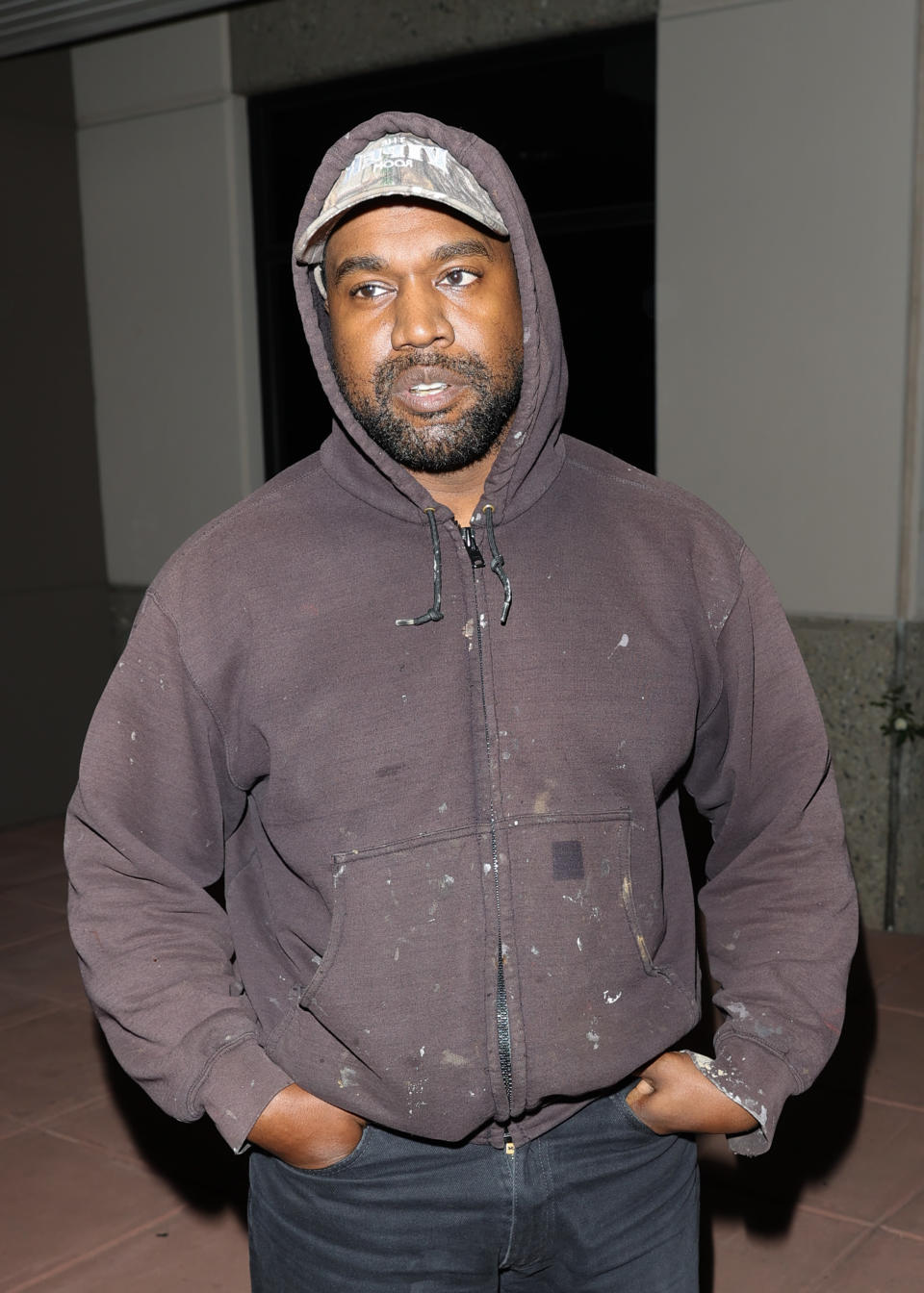Close-up of Ye in a hoodie and jeans