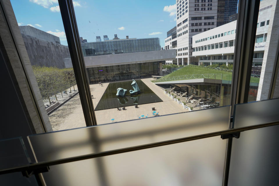 The view of the Paul Milstein Reflecting Pool appears from the newly renovated David Geffen Hall, Thursday, Aug. 25, 2022, at the Lincoln Center for the Performing Arts in New York. After a $550 million renovation that took two years, the New York Philharmonic returns to David Geffen Hall for a series of openings beginning with a Thursday night ribbon-cutting, a Friday performance for construction workers and Saturday afternoon and evening community concerts. (AP Photo/Mary Altaffer)