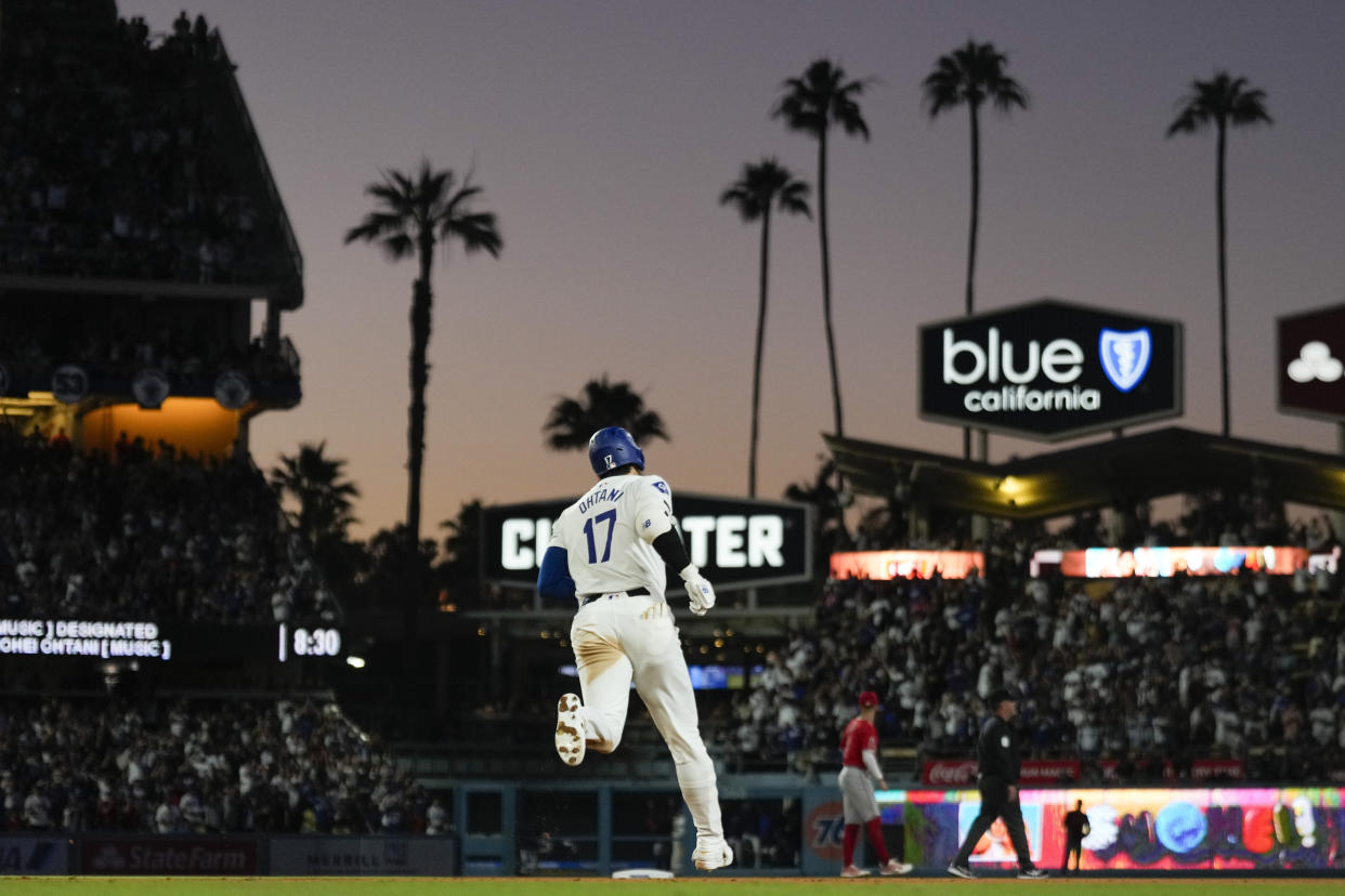 Los Angeles Dodgers designated hitter Shohei Ohtani (17) runs the bases after hitting a home run during the fifth inning of a baseball game against the Los Angeles Angels in Los Angeles, Friday, June 21, 2024. Austin Barnes also scored. (AP Photo/Ashley Landis)