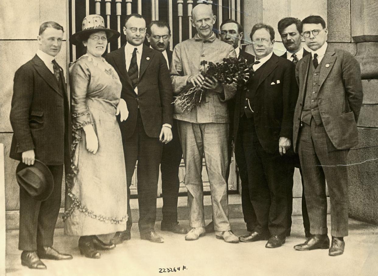 <span class="caption">Eugene Debs, at center with flowers, who was serving a prison sentence for violating the Espionage Act, on the day he was notified of his nomination for the presidency on the socialist ticket by a delegation of leading socialists.</span> <span class="attribution"><a class="link " href="https://www.gettyimages.com/detail/news-photo/for-the-first-time-in-history-a-candidate-for-president-has-news-photo/530858130?adppopup=true" rel="nofollow noopener" target="_blank" data-ylk="slk:George Rinhard/Corbis Historical/Getty Images;elm:context_link;itc:0;sec:content-canvas">George Rinhard/Corbis Historical/Getty Images</a></span>