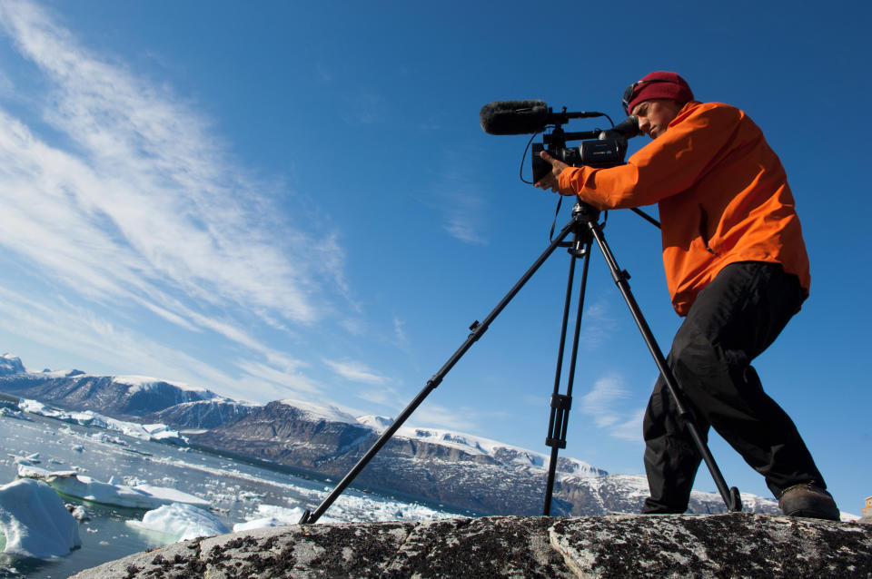 This 2007 photo released by Extreme Ice Survey shows "Chasing Ice" director Jeffery Orlowski shooting in Uummannaq, Greenland. The film, about climate change, follows National Geographic photographer James Balog across the Arctic as he deploys revolutionary time-lapse cameras designed to capture a multi-year record of the world's changing glaciers. (AP Photo/Extreme Ice Survey, James Balog)