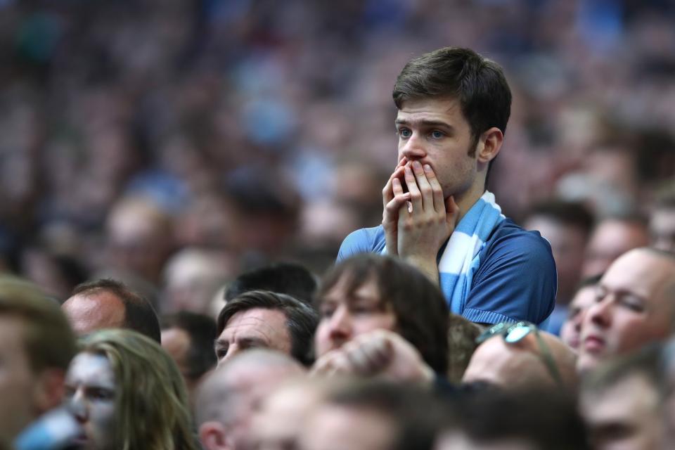 <p>Manchester City fans look on in angst as Arsenal steal a lead in extra-time </p>