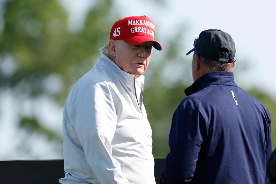 Former President Donald Trump looks on from the first tee during the Pro-Am tournament at LIV Golf.
