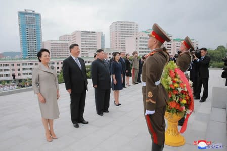 Chinese President Xi Jinping, his wife Peng Liyuan, North Korean leader Kim Jong Un and his wife Ri Sol Ju are seen during Xi's visit in Pyongyang