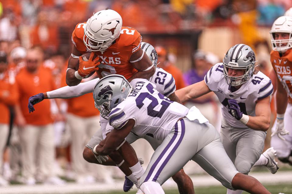 Kansas State linebacker Daniel Green (22) brings down Texas' Roschon Johnson (2) during their game last November in Austin, Texas.