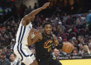 Cleveland Cavaliers' Donovan Mitchell (45) drives to the basket as Memphis Grizzlies' GG Jackson (45) defends during the first half of an NBA basketball game in Cleveland, Wednesday, April 10, 2024. (AP Photo/Phil Long)