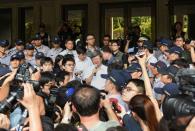 Taiwan Education Minister Wu Se-hwa (C-with glasses) speaks to students during protests at the Education Ministry in Taipei on July 31, 2015