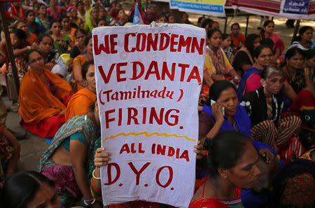 A demonstrator displays a placard during a protest, organised by All India Democratic Youth Organisation, after at least 10 people were killed when police fired on protesters seeking closure of the plant on environmental grounds in Thoothukudi in Tamil Nadu, in Ahmedabad, May 23, 2018. REUTERS/Amit Dave/Files