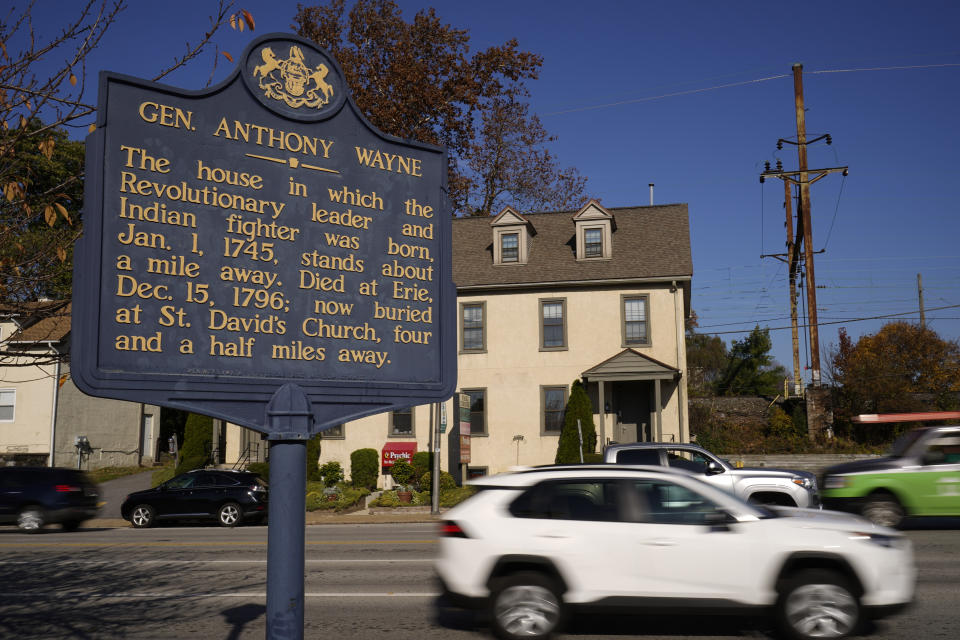 Shown is a Pennsylvania Historical Marker for Revolutionary War Gen. Anthony Wayne in Paoli, Pa., Thursday, Nov. 18, 2021. A recent review of all 2,500 markers the Pennsylvania Historical and Museum Commission had been installing for more than a century, faced a fresh round of questions about just whose stories were being told on the state's roadsides, and the language used to tell them. The increased scrutiny that has focused on factual errors, inadequate historical context and racist or otherwise inappropriate references, prompting the state to remove two markers, revise two and order new text for two others so far. The changes have become grist for the political mill. (AP Photo/Matt Rourke)