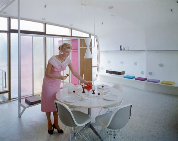 A woman arranges a table centerpiece in the House of the Future at Disneyland in Anaheim, California, in 1957. The model house was a collaboration between the Monsanto Chemical Company, the Massachusetts Institute of Technology (MIT), and Walt Disney Imagineering.