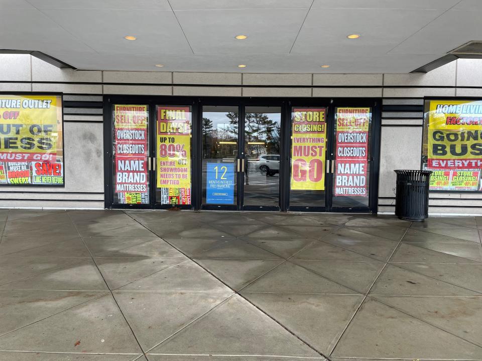 Signs on the outside of the Furniture Outlet location at Monmouth Mall advertise a liquidation sale as the store is closing the location. Dec. 18, 2023.