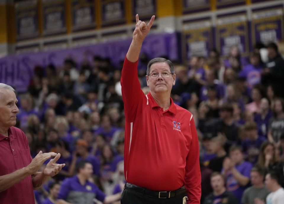 Feb 8, 2022; Mesa, Arizona, U.S.; Mountain View head coach Gary Ernst gives the horns up sign towards fans during a ceremony before playing against Mesa at Mesa High School gym.