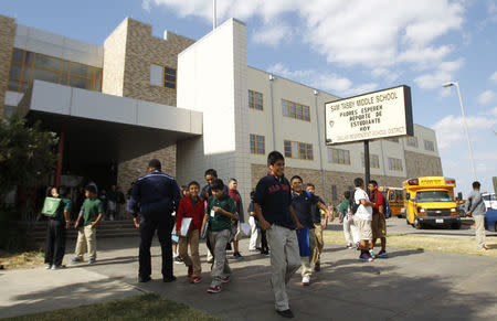 Students leave Tasby Middle School, where a fellow classmate who was in contact with a man diagnosed with the Ebola virus had been removed from school in Dallas, Texas October 1, 2014. REUTERS/Mike Stone