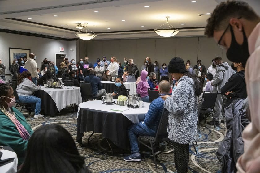 Family and friends wait for word of their loved ones who were at the FedEx Ground facility during a shooting in Indianapolis, Thursday night, April 15, 2021. Multiple people were shot and killed in a late-night shooting at a FedEx facility in Indianapolis, and the shooter killed himself, police said.(Mykal McEldowney/The Indianapolis Star via AP)