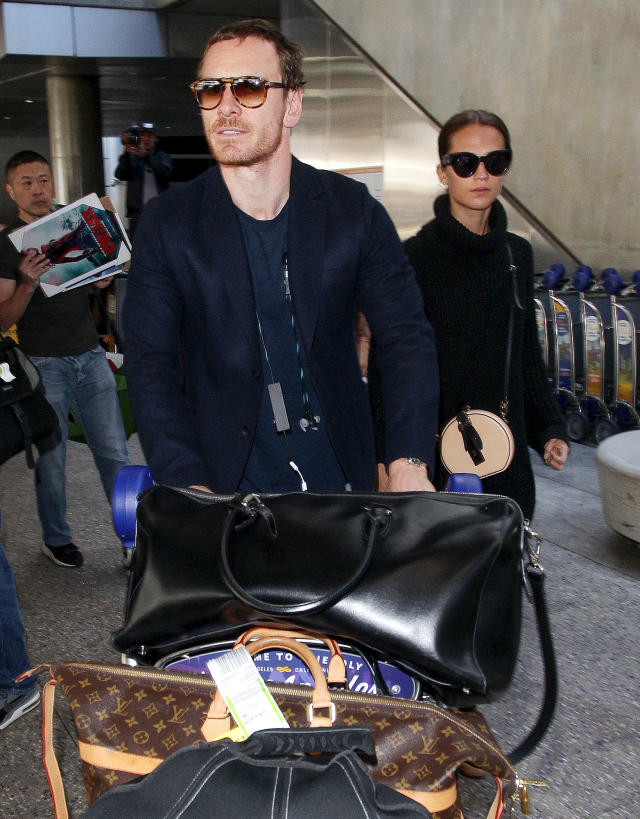 Alicia Vikander carries a large Louis Vuitton bag as she arrives at LAX  Airport in Los