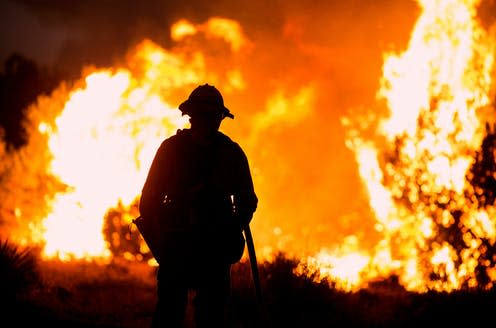 <span class="caption">Wild fires on the US's West Coast displaced many from their homes, making them climate change migrants. </span> <span class="attribution"><a class="link " href="https://www.shutterstock.com/image-photo/firefighter-watches-bobcat-fire-burns-juniper-1818129098" rel="nofollow noopener" target="_blank" data-ylk="slk:Ringo Chiu/Shutterstock;elm:context_link;itc:0;sec:content-canvas">Ringo Chiu/Shutterstock</a></span>