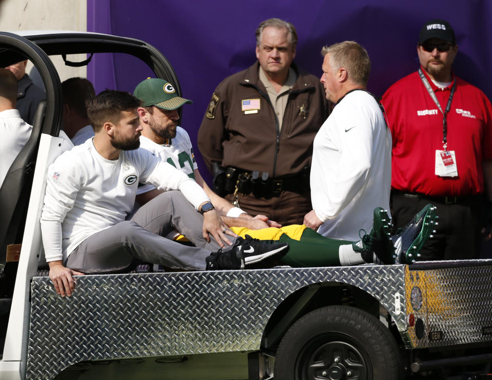 Aaron Rodgers was carted off the field in Minnesota after suffering a big hit from Vikings linebacker Aaron Barr. (AP) 