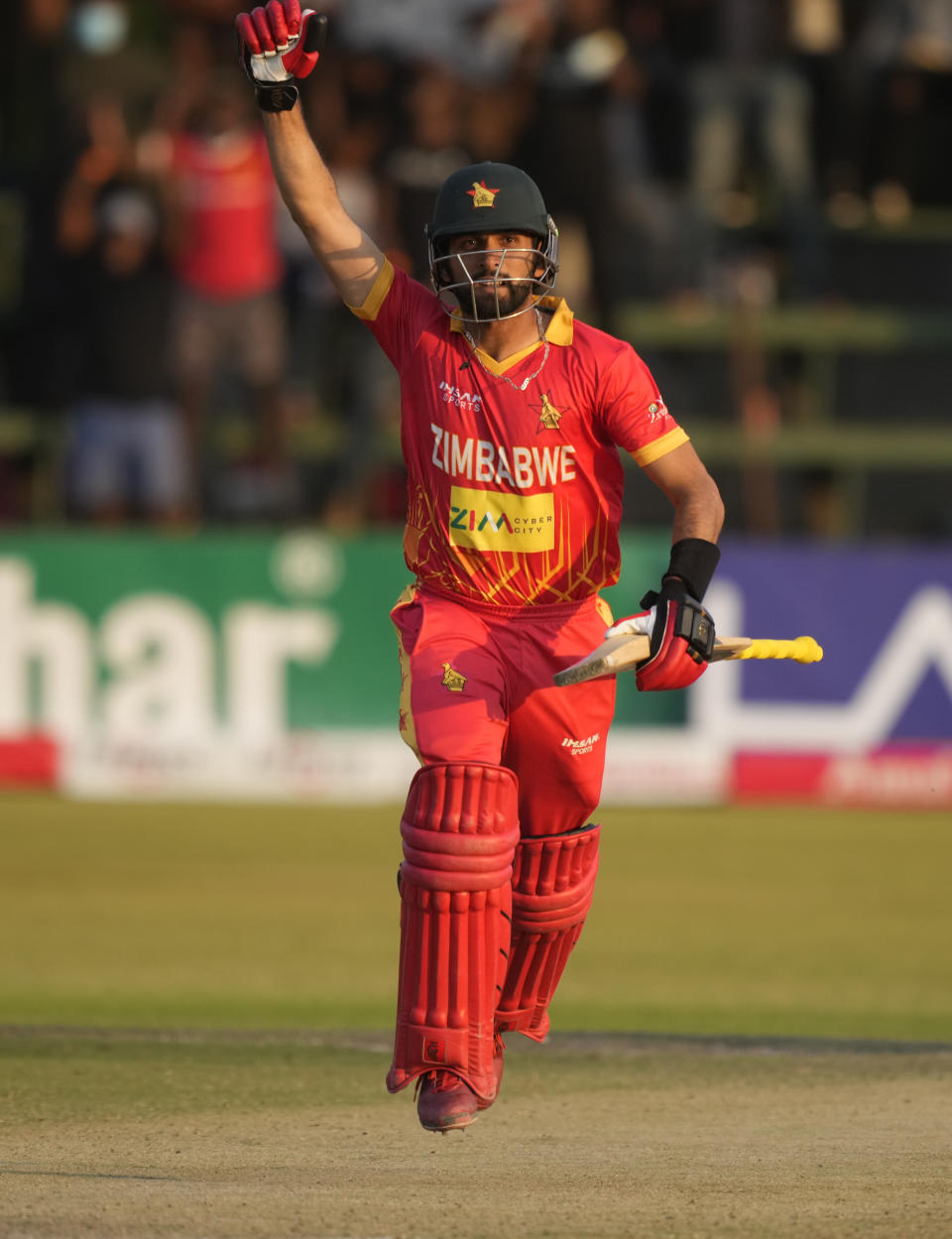 Zimbabwe batsman Sikandar Raza celebrates after scoring 100 runs on the last day of the One-Day International cricket match between Zimbabwe and India at Harare Sports Club in Harare, Zimbabwe, Monday, Aug, 22, 2022. (AP Photo/Tsvangirayi Mukwazhi)