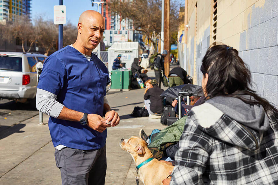 Dr. Kwane Stewart speaks with a homeless woman. (GoFundMe Heroes)