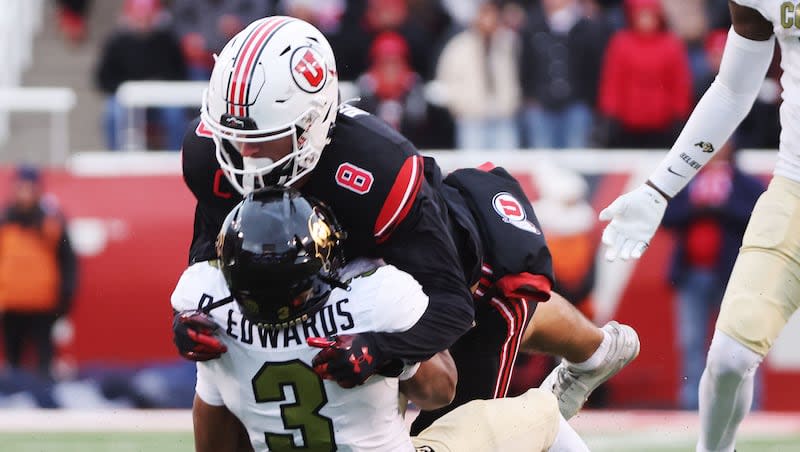 Utah Utes safety Cole Bishop (8) tackles Colorado Buffaloes running back Dylan Edwards (3) in Salt Lake City on Saturday, Nov. 25, 2023. Utah won 23-17.