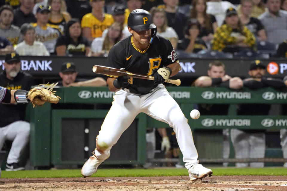 Pittsburgh Pirates' Nick Gonzales lays down a bunt off Miami Marlins relief pitcher George Soriano during the second inning of a baseball game in Pittsburgh, Saturday, Sept. 30, 2023. A throwing error by Soriano on the play allowed a run to score and Gonzales to advance to second. (AP Photo/Gene J. Puskar)