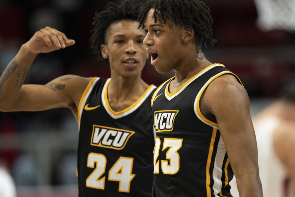 Virginia Commonwealth guard Jayden Nunn (23) celebrates with guard Nick Kern (24) during the first half of an NCAA college basketball game against Davidson in Davidson, N.C., Wednesday, Jan. 26, 2022. (AP Photo/Jacob Kupferman)