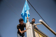 <p>“We are putting up our flags now that the kurds have gone. We took all theirs down. Since last night we can live peacefully, it will be a better life than before” Explains Jihad Khalid, a turkman resident of Kirkuk, raising Turkman flags on Oct. 17, 2017, the day after Iranian group Hashd al Shaabi and the Iraqi Army drove the Kurdish Peshmerga out of the city. (Photo: Elizabeth Fitt/SOPA Images/LightRocket via Getty Images) </p>