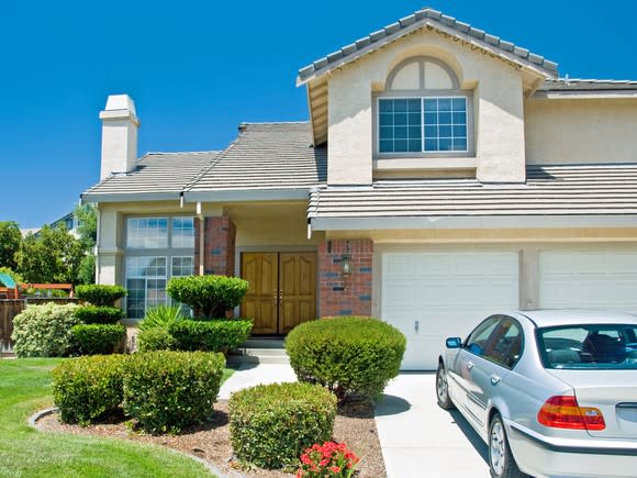 A large house with a car on a driveway