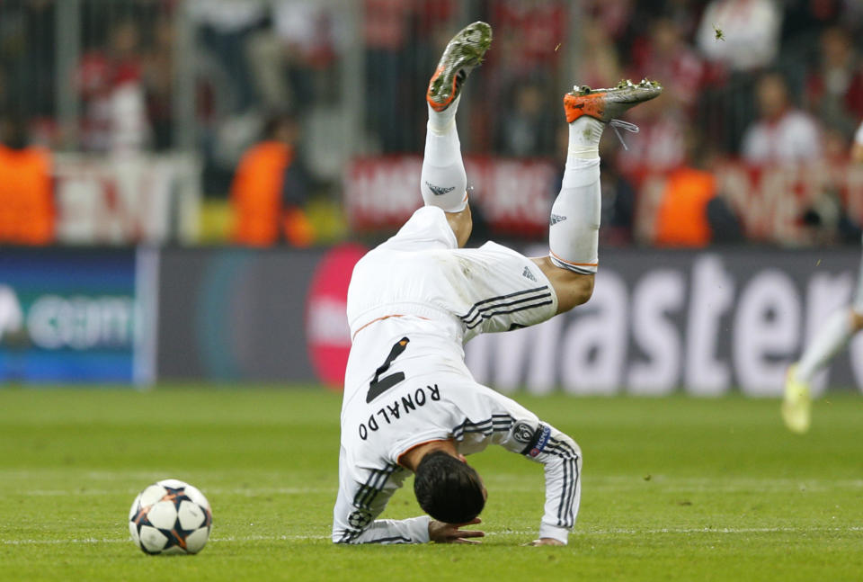 Real's Cristiano Ronaldo is upside down after a foul by Bayern's Dante during the Champions League semifinal second leg soccer match between Bayern Munich and Real Madrid at the Allianz Arena in Munich, southern Germany, Tuesday, April 29, 2014. (AP Photo/Matthias Schrader)